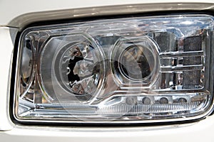 Closeup of modern car lens headlight on a truck