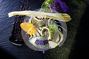 closeup modern decorated fish rolls stuffed with herbs
