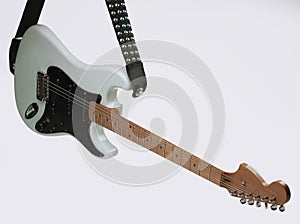 Closeup .modern electric guitar on a white background.