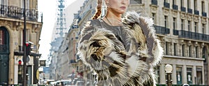 Closeup on modern fashion-monger in fur coat in Paris, France