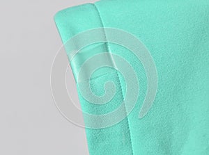 Closeup of modern mint color hood, cowl top fabric with blank transparent label ready to copy paste