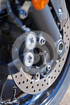 Closeup of Modern Motorcycle Front Braking System With Pads and Disks