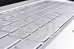 Closeup of a modern silver laptop computer keyboard. Laptop keyboard. Detail of the new and ergonomic computer keyboard