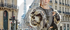 Closeup on modern woman in fur coat in Paris, France