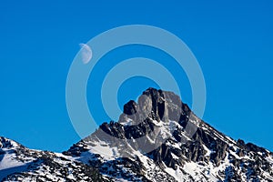 Closeup of moon rising over the mountain peak
