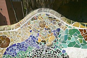 Closeup of mosaic of colored ceramic tile by Antoni Gaudi at his Parc Guell, Barcelona, Spain