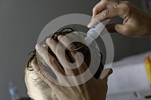 Closeup of a mother checking the hair of her daughter against lice