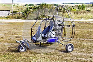 Closeup of moto paraglider on the field.