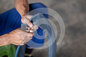 Closeup A motorbike mechanic's hand is inflating a tire. The inner tube of the motorbike that has leaked Checking .