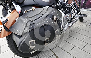 Closeup of a motorcycle with black leather saddlebag