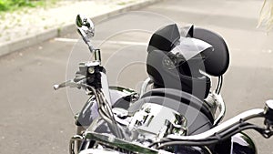 Closeup of a motorcycle and a helmet with cat ears