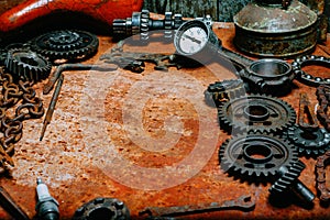 Closeup motorcycle tools, equipment and repair, chain, gearÑ– on vintage metal background