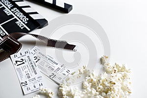 Closeup of movie tickets with popcorn and reels decoration on white table