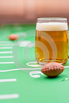 Closeup of a mug of beer on table decorated for superbowl