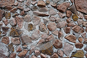 Closeup of multicolored gravel pebble dash on the wall