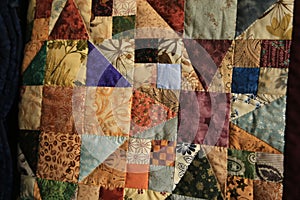 Closeup multicolored squares and triangles Amish Handmade Quilt2