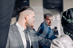 Closeup of multiracial group business men giving high five in office