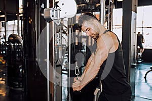 Closeup of a muscular young man lifting weights