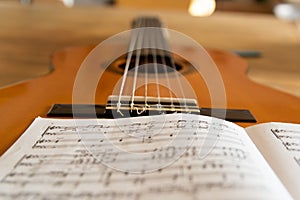 Closeup of a music sheet on a guitar
