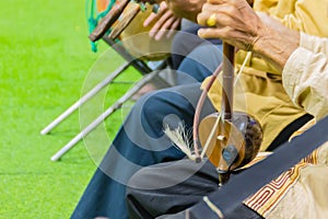 Closeup the musician during play the Salor (Lanna Traditional Fiddle), a Thai musical instrument such as stringed instruments.