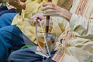 Closeup the musician during play the Salor (Lanna Traditional Fiddle), a Thai musical instrument such as stringed instruments.