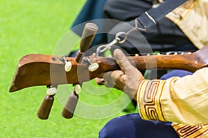 Closeup the musician during play the Sueng, a plucked fretted lute from the northern region of Thailand. This musical instrument