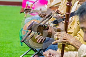 Closeup the musician during play the Sueng, a plucked fretted lute from the northern region of Thailand. This musical instrument