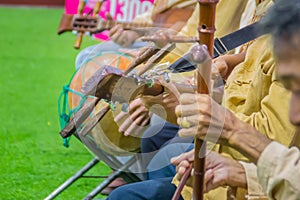 Closeup the musician during play the Sueng, a plucked fretted lute from the northern region of Thailand. This musical instrument