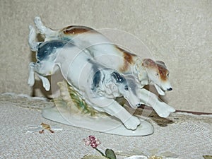 Closeup muzzle greyhounds. Swift Russian greyhounds on the hunt. Retro porcelain figurine of hunting dogs, collection.