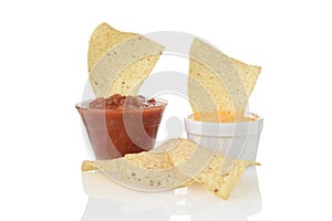 Closeup nacho corn chips dipped in cheese and salsa