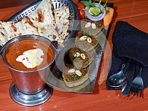 Closeup of Naram dil kabab served with maa ki daal and butter naan photo