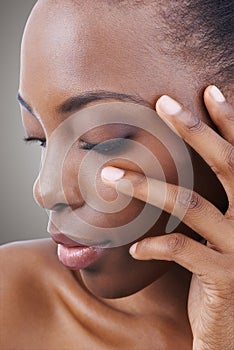 Closeup on natural beauty. Studio shot of a beautiful african american model isolated on gray.