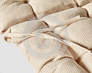 Closeup of natural beige fabric covering of chair cushion