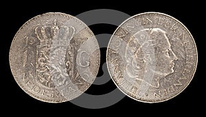 Closeup of Netherlands one gulden coins with queen Juliana on a dark background