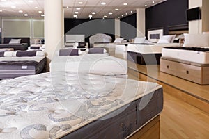 Closeup of new modern orthopaedic mattress on display for sale in large furniture store