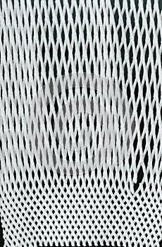 Textureof white packaging synthetic mesh on black background. Nylon white macro texture pattern background.
