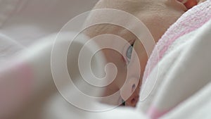 A closeup of a newborn baby girls face