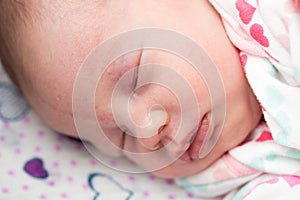 Closeup of a newborn baby sleeping in the crib,