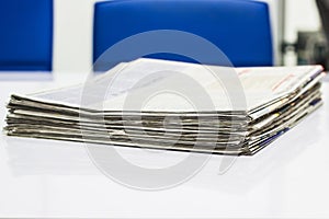 Newspaper Stack on white table