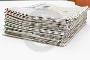 Newspaper Stack on white table