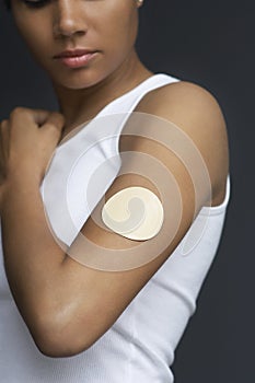 Closeup Of Nicotine Patch On Female's Arm