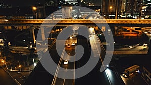 Closeup night traffic highway: cars drive aerial. Urban transport ride at road. Philippine cityscape
