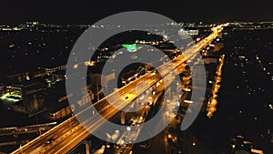 Closeup night traffic highway with driving cars, trucks aerial. Philippines Manila town cityscape