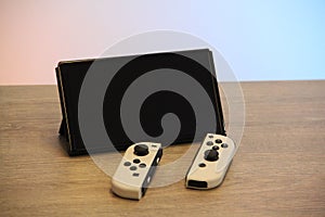 Closeup of a Nintendo Switch OLED Gaming Handheld on a wooden table