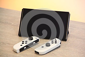 Closeup of a Nintendo Switch OLED Gaming Handheld on a wooden table