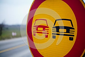 Closeup of a NO OVERTAKING sign along the road