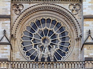 Closeup of the Notre Dame de Paris Cathedral facade with the oldest rose window installed in 1225 which forms a halo above the