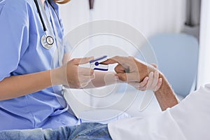 closeup nurse doctor using fingertip pause oximeter measures blood oxygen saturation level with patient