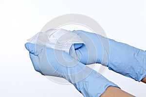 Closeup of nurse hands in surgical gloves openning sterile wound dressing compress photo