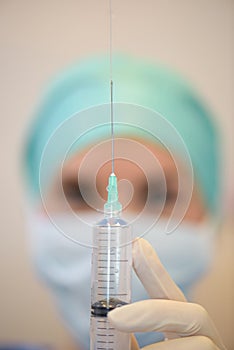 Closeup nurse measuring dose in syringe